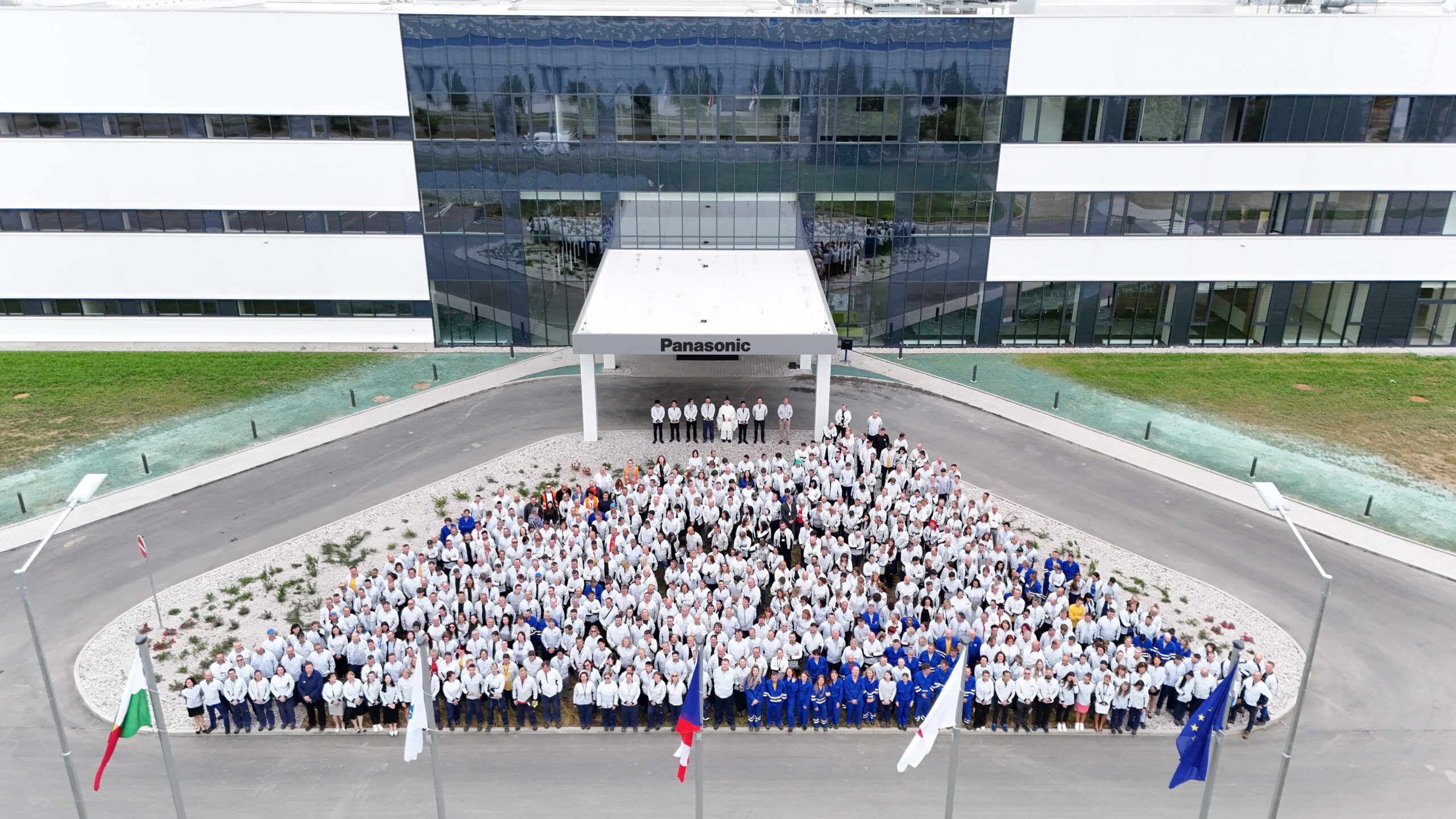 New Facility with Factory Workers Outside Aerial